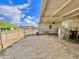 Covered horse stall featuring a white horse, ample space, and access to an outdoor paddock at 15602 N 37Th St, Phoenix, AZ 85032