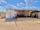 Outdoor horse stall area with shaded shelter, fencing, and storage shed on a sunny day at 15602 N 37Th St, Phoenix, AZ 85032