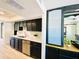 Galley kitchen featuring black cabinetry, stainless steel appliances, and light, neutral-toned floors at 15602 N 37Th St, Phoenix, AZ 85032