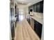 Galley kitchen featuring black cabinetry, stainless steel appliances, and light, neutral-toned floors at 15602 N 37Th St, Phoenix, AZ 85032