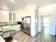 Bright kitchen features stainless steel appliances, white cabinetry, farmhouse sink, and stylish countertops at 15602 N 37Th St, Phoenix, AZ 85032