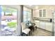 Bright kitchen with white cabinets, granite counters, and an adjacent outdoor patio with seating at 15602 N 37Th St, Phoenix, AZ 85032