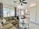 Comfortable open-plan living room featuring couch, coffee table, kitchen, and ample natural light at 15602 N 37Th St, Phoenix, AZ 85032