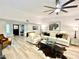 Bright living room with modern flooring, neutral furniture, and a large ceiling fan at 15602 N 37Th St, Phoenix, AZ 85032