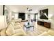 Bright living room features a fireplace, white baby grand piano, and contemporary furnishings with neutral tones at 15602 N 37Th St, Phoenix, AZ 85032