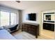 Comfortable main bedroom featuring a large window, dresser, and ensuite bathroom at 15602 N 37Th St, Phoenix, AZ 85032
