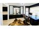Home office featuring black built-in cabinets, a desk, and a cowhide rug on light, neutral-toned floors at 15602 N 37Th St, Phoenix, AZ 85032