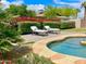 Inviting pool area with lounge chairs, lush landscaping, and a serene atmosphere at 15602 N 37Th St, Phoenix, AZ 85032