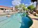 Private backyard oasis with a pool, rock waterfall, and covered patio at 15602 N 37Th St, Phoenix, AZ 85032