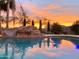 Backyard pool area with a water slide feature and landscape lighting at sunset at 15602 N 37Th St, Phoenix, AZ 85032