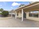 Covered patio area featuring a large brick surface, pergola, and a sliding glass door to the interior at 15822 W Alpine Ridge Dr, Surprise, AZ 85374