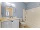 Bright bathroom features a single sink vanity with tub and shower, all in cool, neutral tones at 15822 W Alpine Ridge Dr, Surprise, AZ 85374