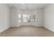 Bright carpeted bedroom with a large bay window and ceiling fan at 15822 W Alpine Ridge Dr, Surprise, AZ 85374