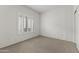 Carpeted bedroom with white walls and a window with wooden blinds at 15822 W Alpine Ridge Dr, Surprise, AZ 85374