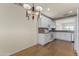Dining room featuring wood floors, a hanging chandelier, and white kitchen cabinetry at 15822 W Alpine Ridge Dr, Surprise, AZ 85374