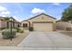 Inviting single-story home featuring a two-car garage, neutral stucco, and low-maintenance desert landscaping at 15822 W Alpine Ridge Dr, Surprise, AZ 85374