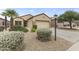 Charming front exterior with desert landscaping, featuring a well-maintained lawn and mature palm tree at 15822 W Alpine Ridge Dr, Surprise, AZ 85374