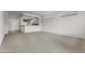 Spacious carpeted living room with view to the kitchen at 15822 W Alpine Ridge Dr, Surprise, AZ 85374
