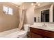 Tiled bathroom showcases a shower over tub combination, modern vanity and sink, and soft lighting at 16225 N 30Th St # 11, Phoenix, AZ 85032