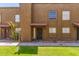 Inviting townhouse exterior features a red tile roof, secure front door, and manicured lawn at 16225 N 30Th St # 11, Phoenix, AZ 85032