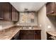 Kitchen sink area with wood cabinets, laminate countertops, and a view from the window at 16225 N 30Th St # 11, Phoenix, AZ 85032