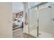 Bright bathroom showing a walk-in shower with glass surround, seat, and white marble tiling at 16381 W Weeping Willow Rd, Surprise, AZ 85387