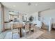 Bright dining room showcasing pendant lighting, view into kitchen, and nearby stairway at 16381 W Weeping Willow Rd, Surprise, AZ 85387