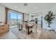 Elegant dining area with patio access, modern furnishings, and view into kitchen at 16381 W Weeping Willow Rd, Surprise, AZ 85387