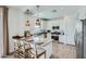 Modern kitchen featuring a quartz countertop island with seating, stainless steel appliances, and white cabinetry at 16381 W Weeping Willow Rd, Surprise, AZ 85387