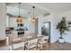 Modern kitchen featuring a quartz countertop island with seating, stainless steel appliances, and white cabinetry at 16381 W Weeping Willow Rd, Surprise, AZ 85387