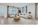 Bright living room with neutral decor, stylish furniture, and natural light from the large windows at 16381 W Weeping Willow Rd, Surprise, AZ 85387