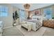 Serene main bedroom with a large bed, accent wall, designer lighting, and decorative accents at 16381 W Weeping Willow Rd, Surprise, AZ 85387