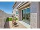 Private outdoor patio with brick paving, lounge furniture, and sliding glass door access to home at 16381 W Weeping Willow Rd, Surprise, AZ 85387