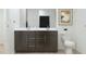 Well-lit bathroom featuring a double sink vanity, a toilet, and neutral decor at 16677 W Chama Dr, Surprise, AZ 85387