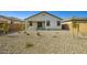 A gravel backyard with privacy fencing and a covered patio at 16754 W Alameda Rd, Surprise, AZ 85387