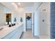 Bright bathroom featuring a walk-in shower, dual sinks, and a large mirror for a spa-like experience at 16754 W Alameda Rd, Surprise, AZ 85387