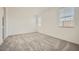 Spacious bedroom features neutral carpet and two bright windows at 16754 W Alameda Rd, Surprise, AZ 85387