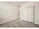 Bright bedroom featuring plush carpet, closet and interior door at 16754 W Alameda Rd, Surprise, AZ 85387