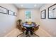 Cozy dining room with a round table, four chairs, and natural light from the window at 16754 W Alameda Rd, Surprise, AZ 85387