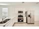 Modern kitchen boasts stainless steel appliances, white cabinets, and ample counter space at 16754 W Alameda Rd, Surprise, AZ 85387