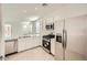 This modern kitchen offers stainless steel appliances, a dishwasher and a view of the living area at 16754 W Alameda Rd, Surprise, AZ 85387