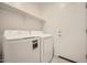 Functional laundry room with modern washer and dryer, and convenient storage shelf at 16754 W Alameda Rd, Surprise, AZ 85387