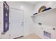 Clean laundry room with shelving, providing an organized and efficient space for laundry tasks at 16754 W Alameda Rd, Surprise, AZ 85387