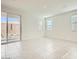 Bright living room with sliding glass doors to the backyard and light tile floors at 16754 W Alameda Rd, Surprise, AZ 85387
