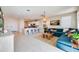 Open concept living room with a kitchen, comfortable seating, and stylish decor at 16754 W Alameda Rd, Surprise, AZ 85387