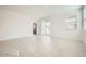 Sun-filled living area with tile flooring and neutral walls, leading to a sliding glass door at 16754 W Alameda Rd, Surprise, AZ 85387