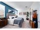 Comfortable bedroom featuring carpeted floors, white bedding, and soothing blue accent wall at 16754 W Alameda Rd, Surprise, AZ 85387
