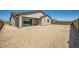 The expansive backyard features a covered patio, potential for landscaping, and privacy walls at 16781 W Bronco Trl, Surprise, AZ 85387