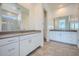 Bright bathroom featuring dual sinks with modern fixtures and tile flooring at 16781 W Bronco Trl, Surprise, AZ 85387