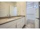 A bathroom featuring double sinks, modern fixtures, and access to a shower/tub combo at 16781 W Bronco Trl, Surprise, AZ 85387